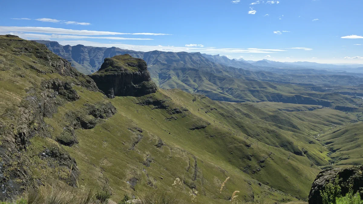 Green valleys and high cliffs under a blue sky