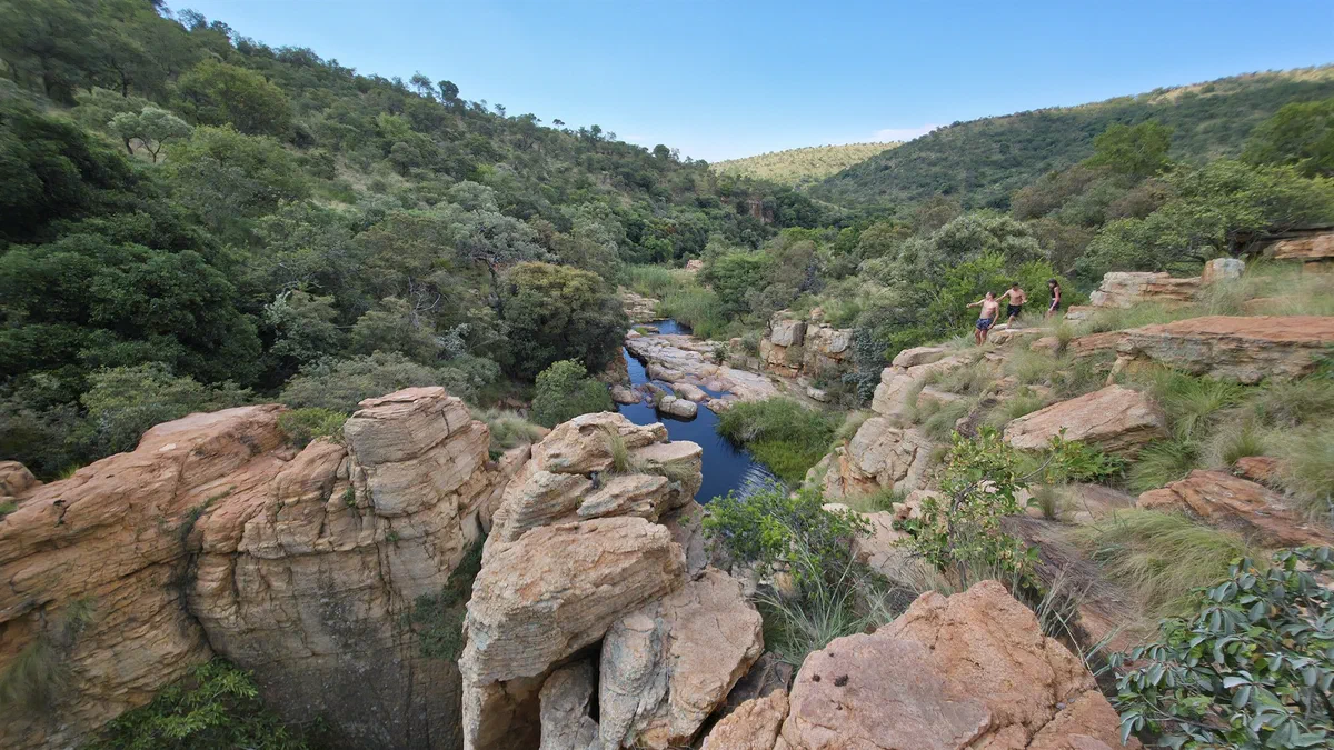 A river winding through a rocky gorge between wooded hills